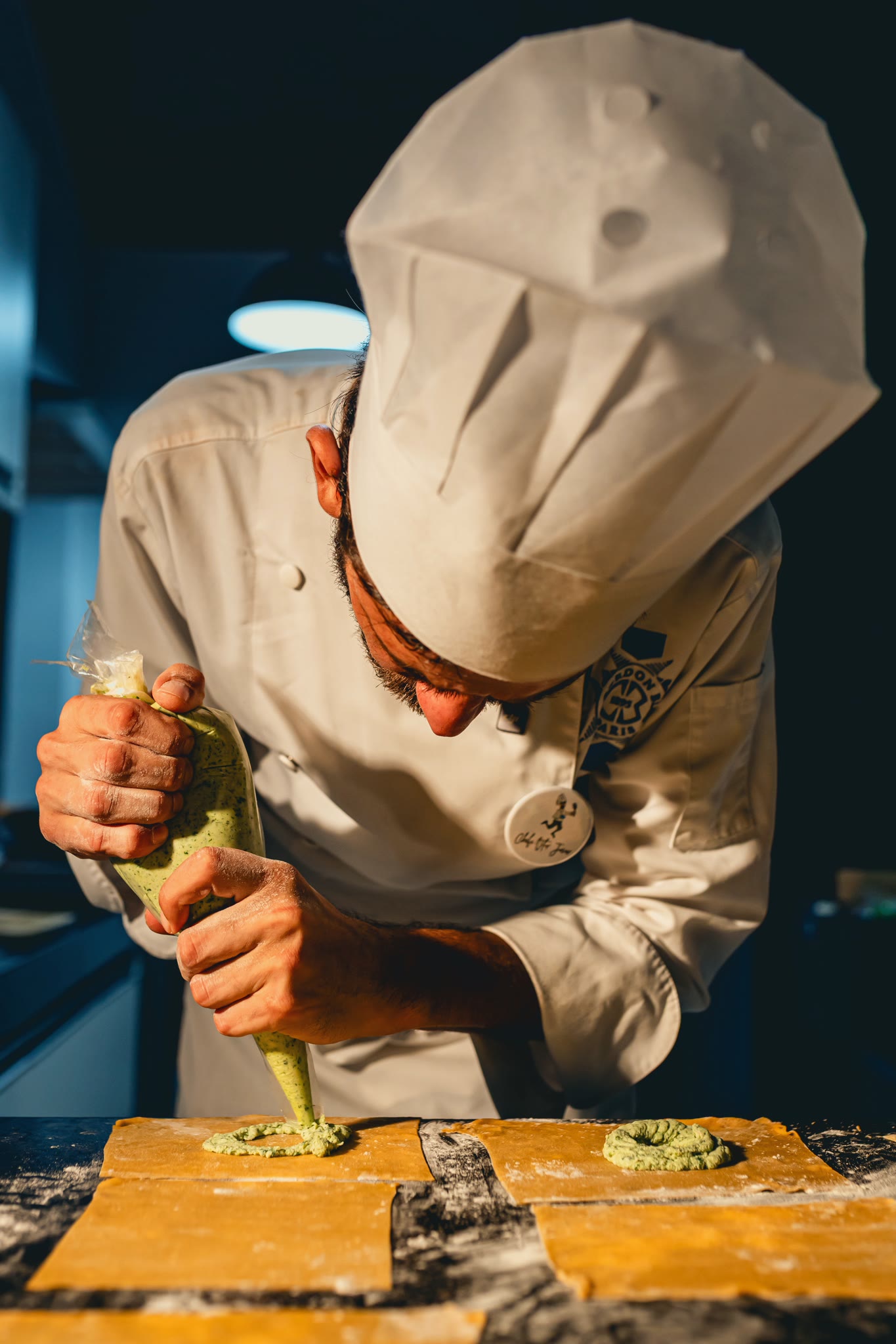Chef Vitor Jover piping the filling onto the fresh pasta