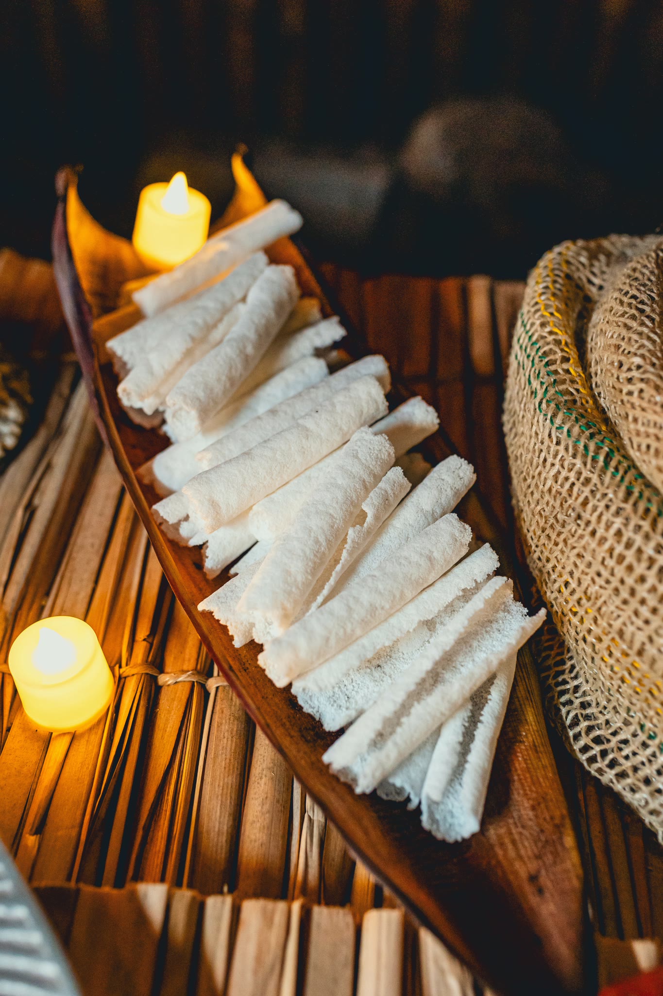 Rolled beijus served on a wooden canoe